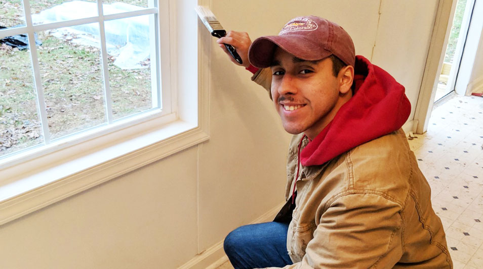 Hampden-Sydney student volunteer painting the interior of a Habitat for Humanity home