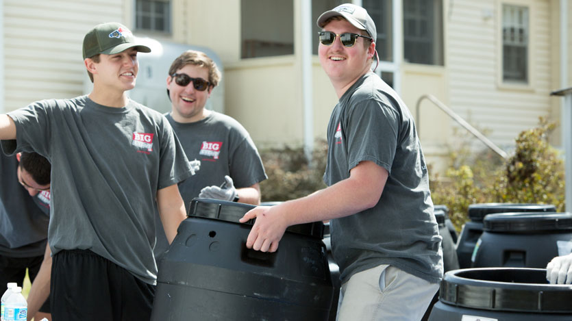 Students moving rain barrels at Hampden-Sydney College's The Big Event