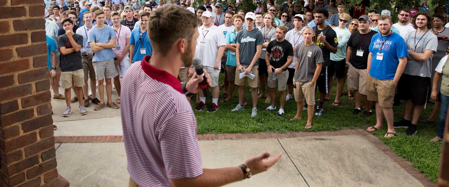 A Hampden-Sydney student leading freshman orientation at the Bell Tower