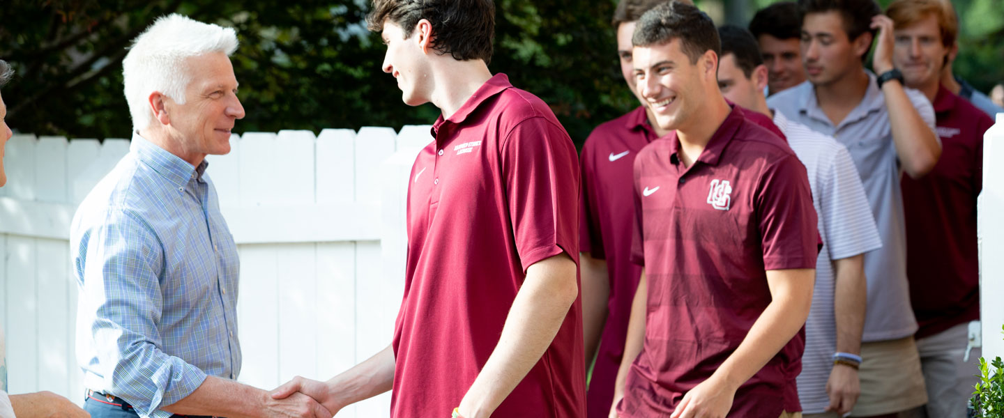 New students smiling and shaking hands with the president at Hampden-Sydney College