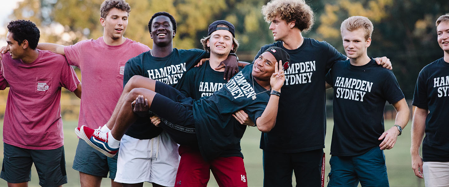 Hampden-Sydney College friends holding up another in a group