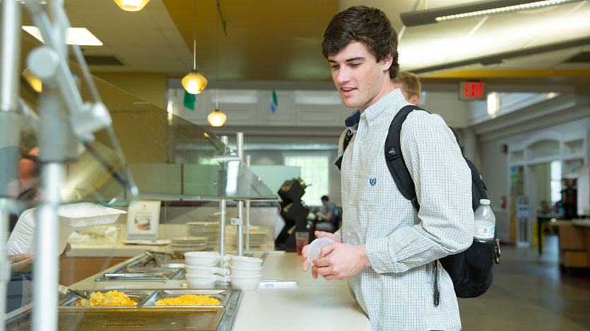 Student browsing the options in the dining hall