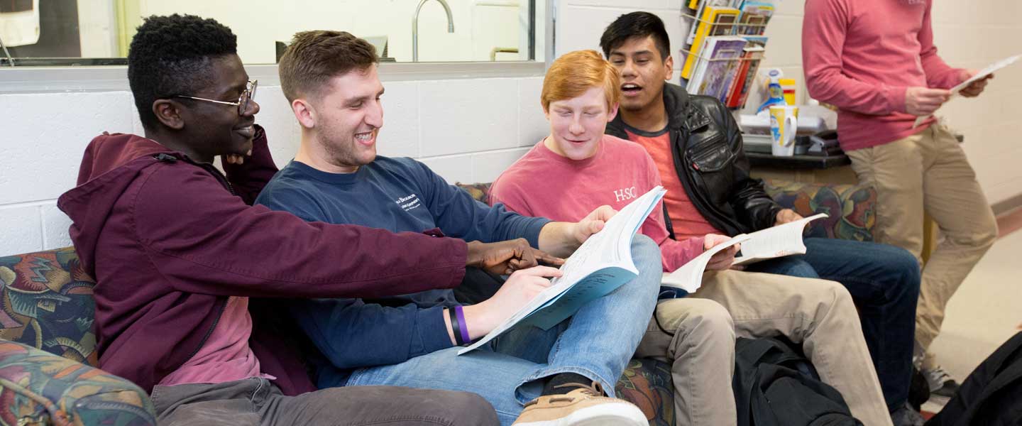 Students reading a book together at Hampden-Sydney College
