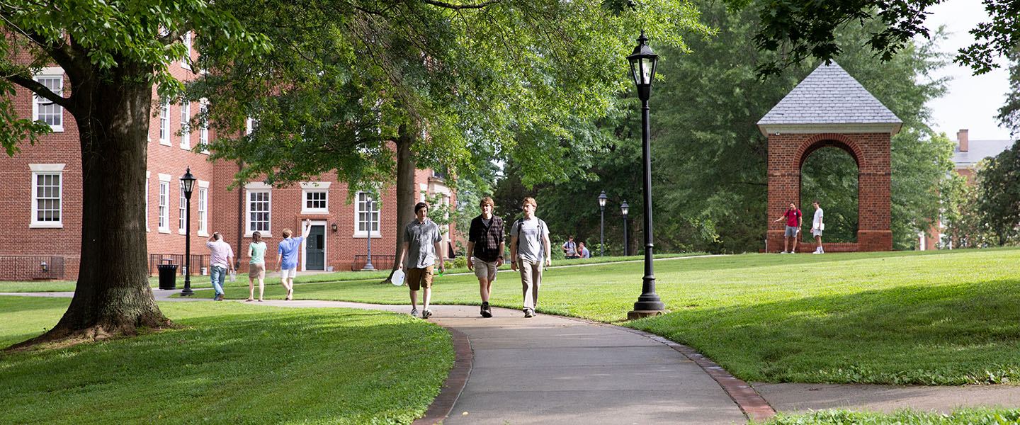 Students laughing and walking along a path at Hampden-Sydney College.