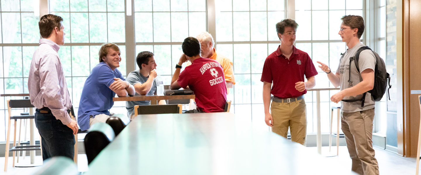 Students hanging out in front of windows in Brown Student Center