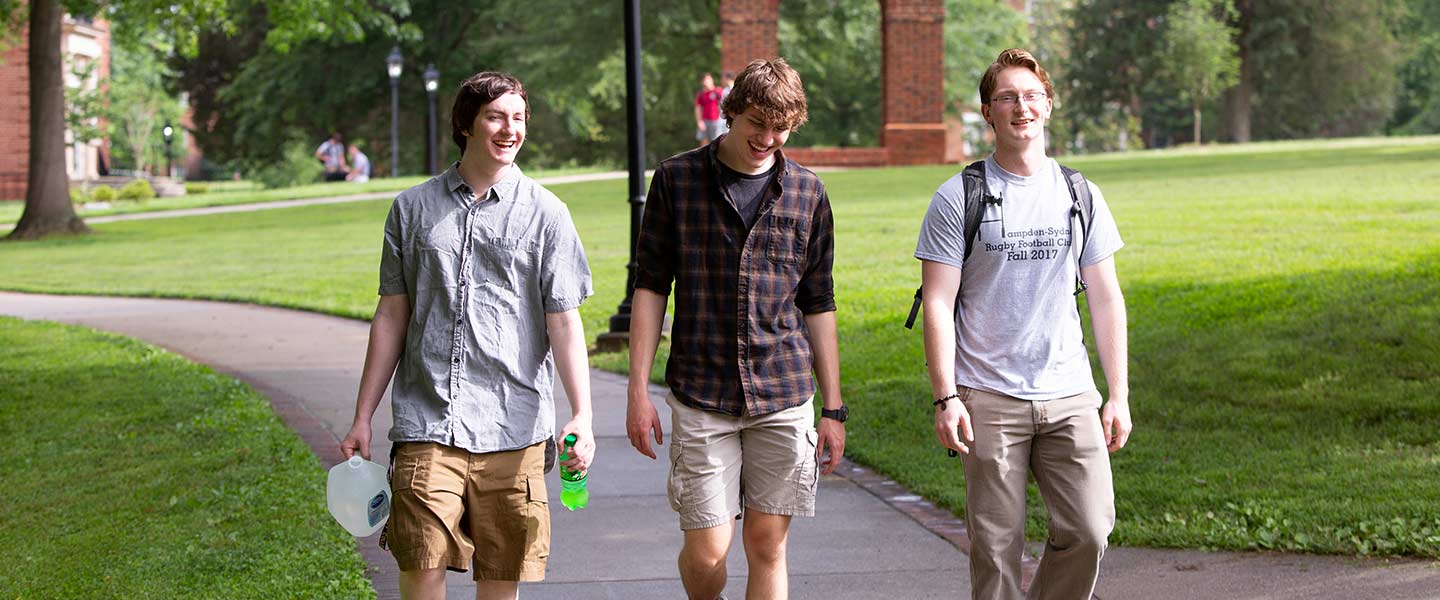 Students laughing and walking along a path at Hampden-Sydney College.