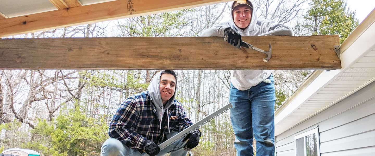 Hampden-Sydney student volunteers working on a roof of a Habitat house
