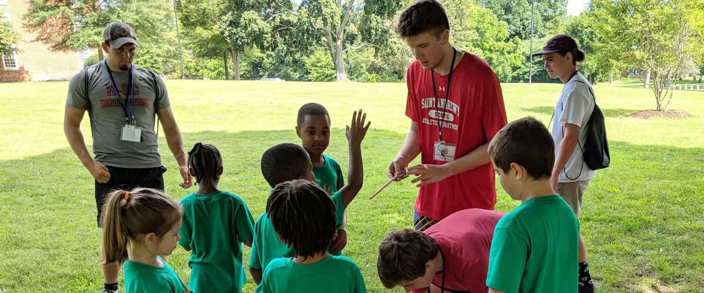 A Hampden-Sydney College leads children in an outdoor game