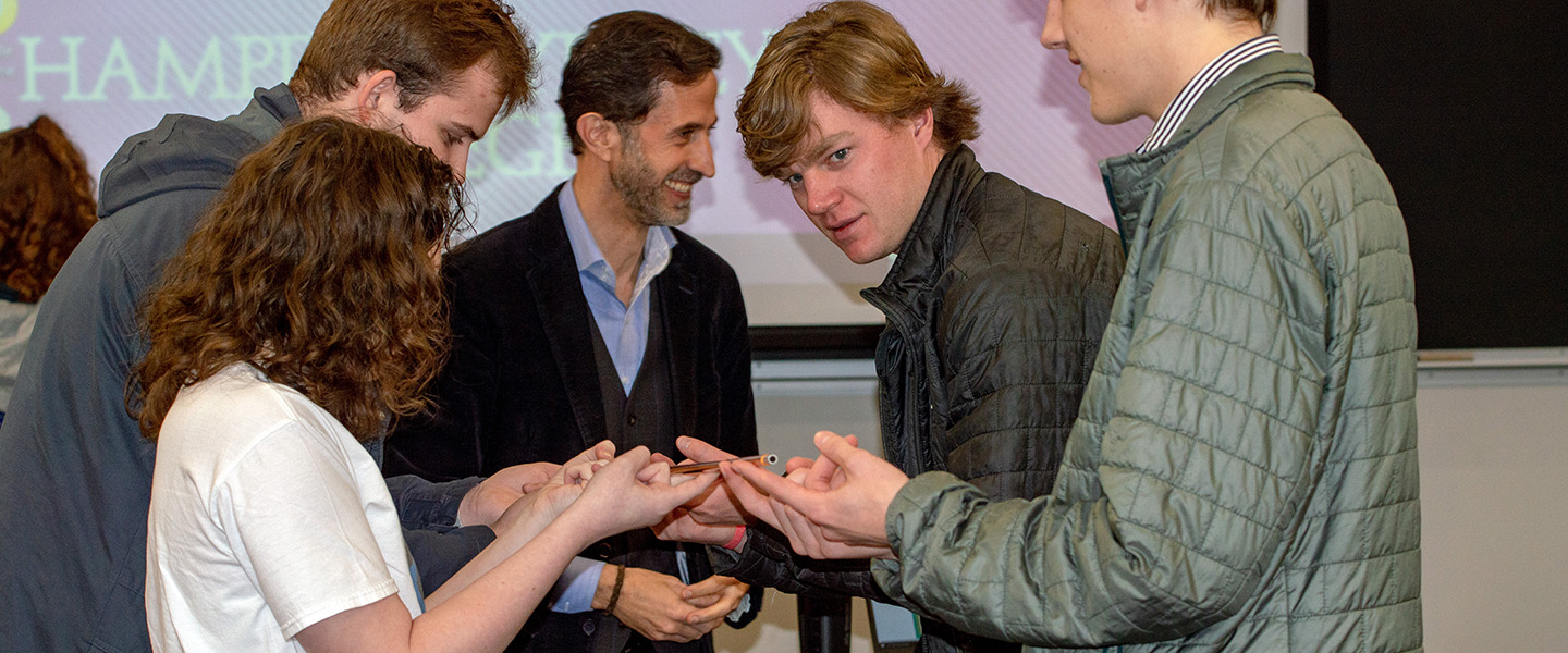 Professor Andrew King and students cooperate in a hands on activity during a lecture